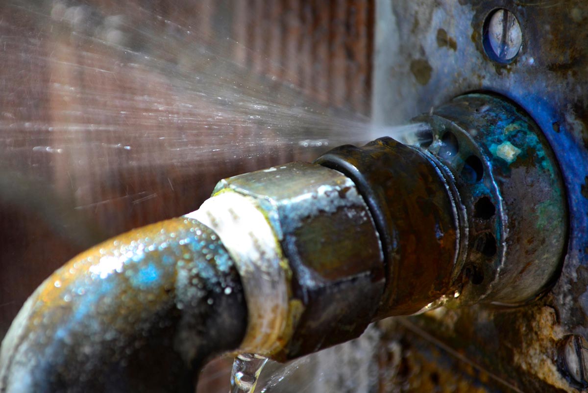 Older residential plumbing pipes being inspected for wear and deterioration